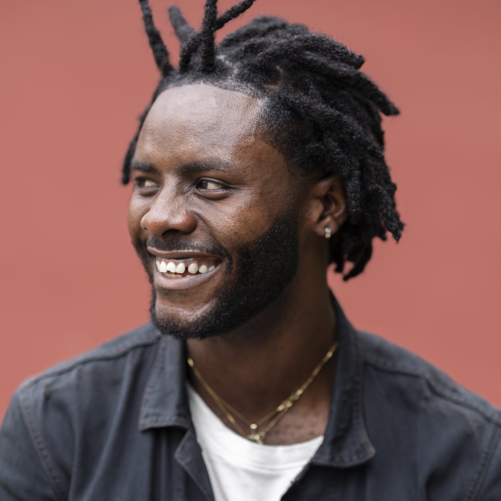 Young man with afro dreadlocks in jacket