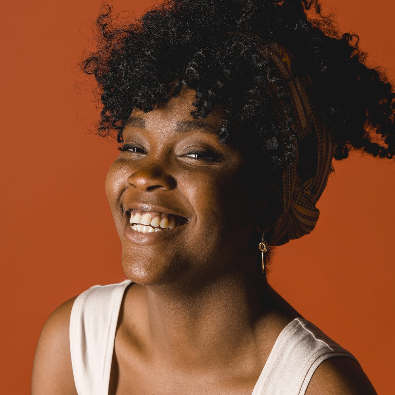 Smiling young Black woman in colorful t-shirt